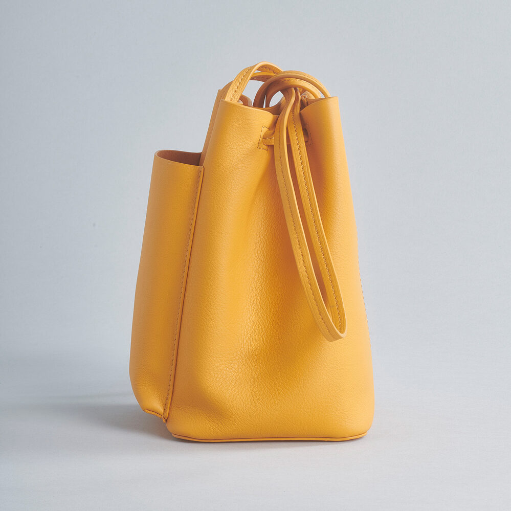 bucket bag soft leather outside pocket shoulder strap yellow orange