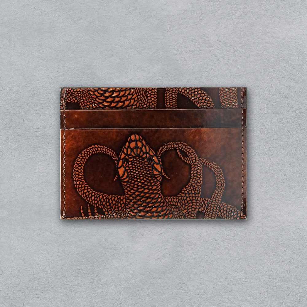 compact cardholder in glazed leather with hand embossed brown lizard motif