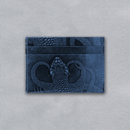 compact cardholder in glazed leather with hand embossed lizard motif in navy blue